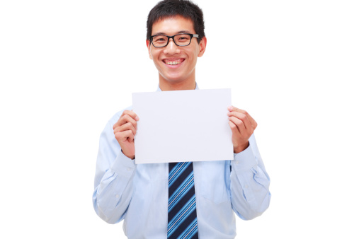 picture of one young happy asian businessman holding white card and looking at camera smile.