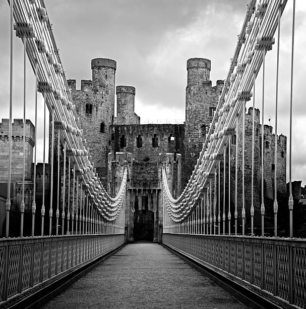 Drawbridge to Conwy Castle Modern Drawbridge leading to Conwy Castle's Gatehouse in black and white. conwy castle stock pictures, royalty-free photos & images
