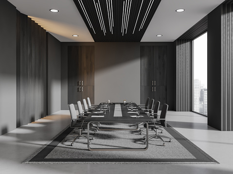 Interior of stylish meeting room with gray and dark wooden walls, concrete floor, long conference table with gray chairs standing on gray carpet. 3d rendering