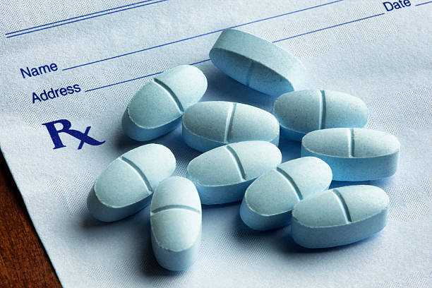 Hydrocodone with Acetaminophen Tablets on a Prescription Form stock photo