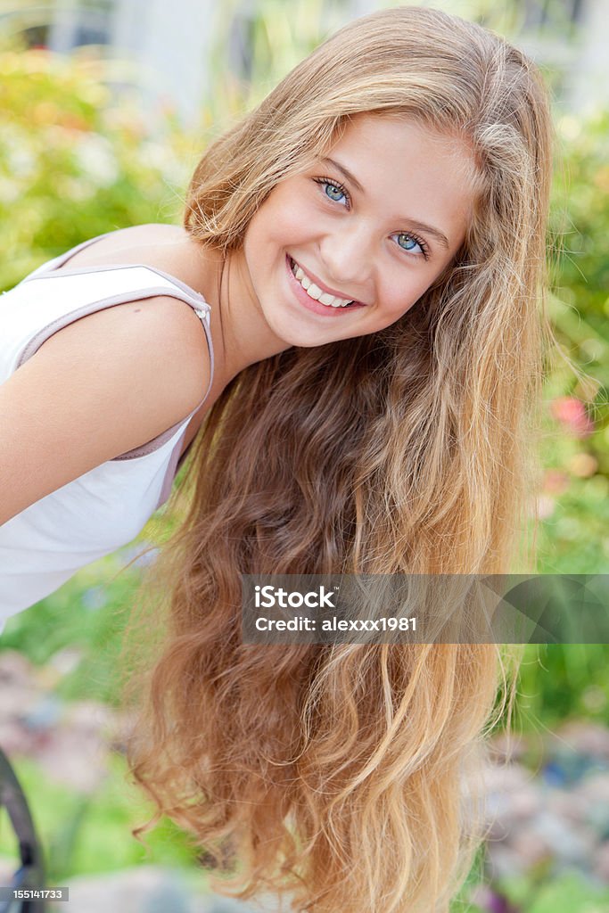 Portrait of cheerful teenage girl posing, smiling expressing positivity outdoors  14-15 Years Stock Photo