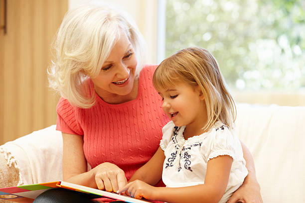 istock Grandmother and granddaughter reading 155142126