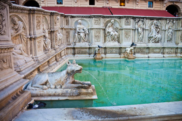 A section of the Fonte Gaia in the Piazza del Campo in central Siena. It is an 19th century copy of the original fountain which was designed by Jacopo della Quercia and constructed between 1414 and 1419. The original is currently undergoing restoration and preservation.