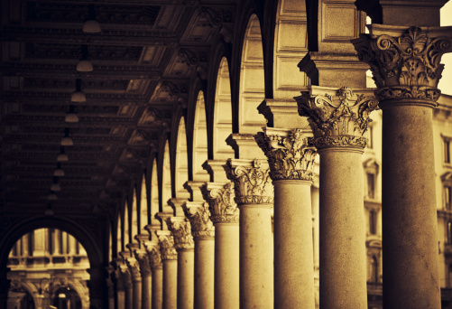 black and white columns of a building with shadows