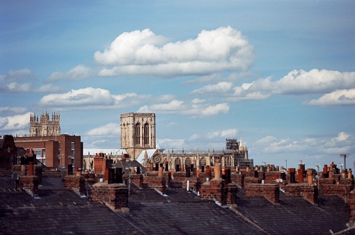 York, England, 2011: A level view of the rooftops taken from the walls, with the Cathedral well visible