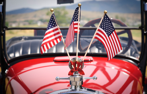 Three small United States flags decorate the hood of an old Ford. Adobe RGB color space.