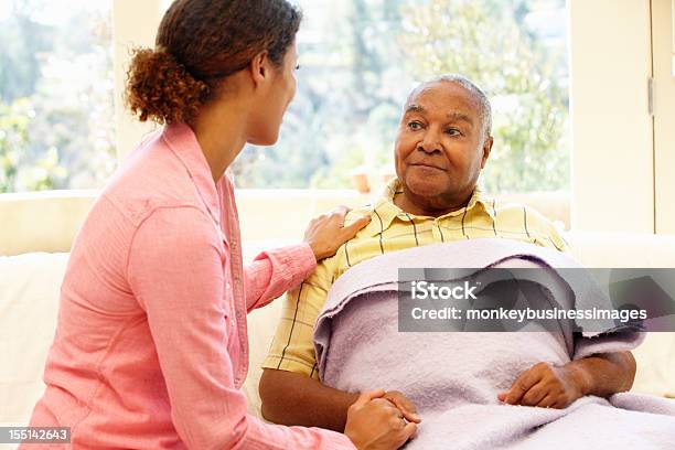 Daughter Tending To Her Sick Father Stock Photo - Download Image Now - Senior Adult, Illness, Father