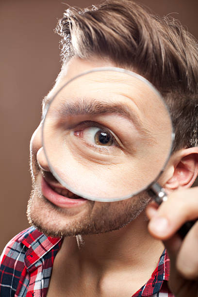 istock Portrait of a man with magnifying glass 155143017