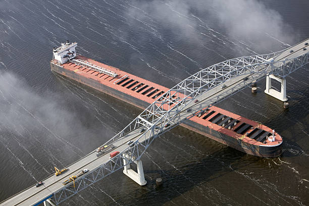 istock Cargo Ship Enters Port under Bridge Aerial 155143070