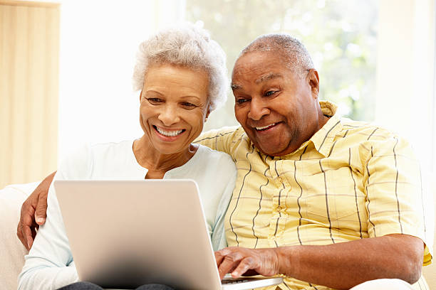 istock Senior African American couple laughing on their computer 155143098