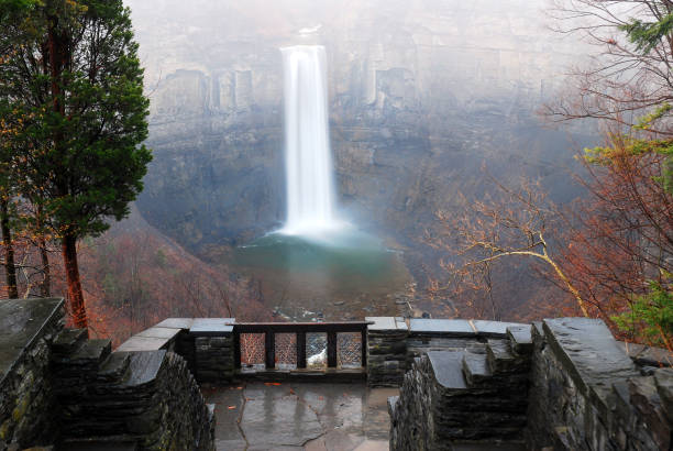 Taughannock Falls, New York Taughannock Falls cascades through a gorge as seen from on observation deck in a Park on a rainy autumn day finger lakes stock pictures, royalty-free photos & images