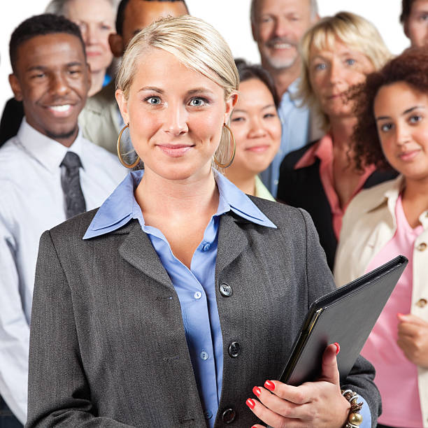 istock Pretty young businesswoman in front of peer group 155143216