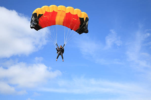 parachutist in aria - parachuting foto e immagini stock