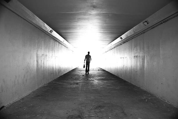 istock Lone businessman walking through tunnel with briefcase 155143416