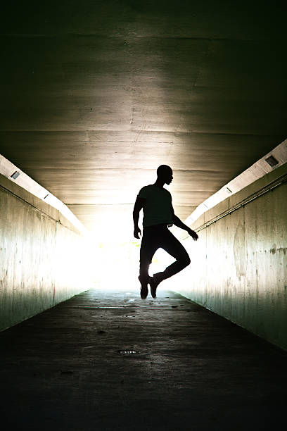 istock Lone man jumping in tunnel 155143419