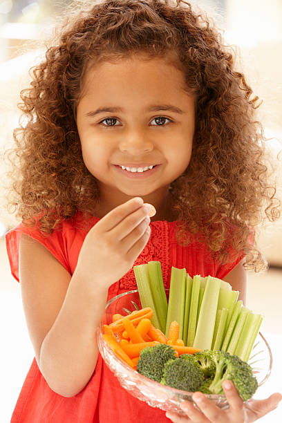 istock Little girl eating raw vegetables 155143481