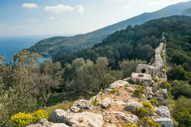 Ruins of old Roman Aqueduct. View Delikkemer Bridge at olive forest near Mediterranean sea coast. Near to Patara Ancient City at location Kalkan, Kas, Antalya. Popular travel destination in Turkey