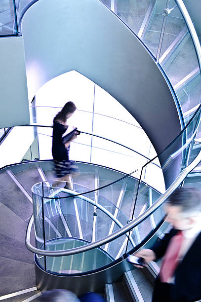 istock Business People Descend Spiral Staircase 155143630