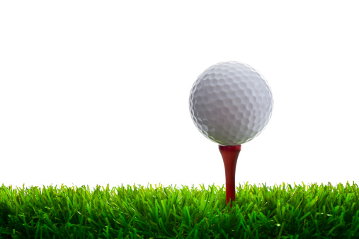 Golf Ball and Tee on grass. Isolated on white.
