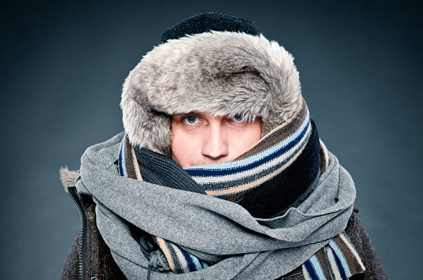 uomo in abbigliamento invernale è strettamente integrato, tappo, sciarpe - warm clothing foto e immagini stock