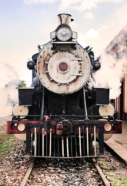 Passengers board a train at Ayutthaya Railway Station in the early morning light—a quiet moment of daily life and travel in Thailand. Ayutthaya, Thailand; May 2025
