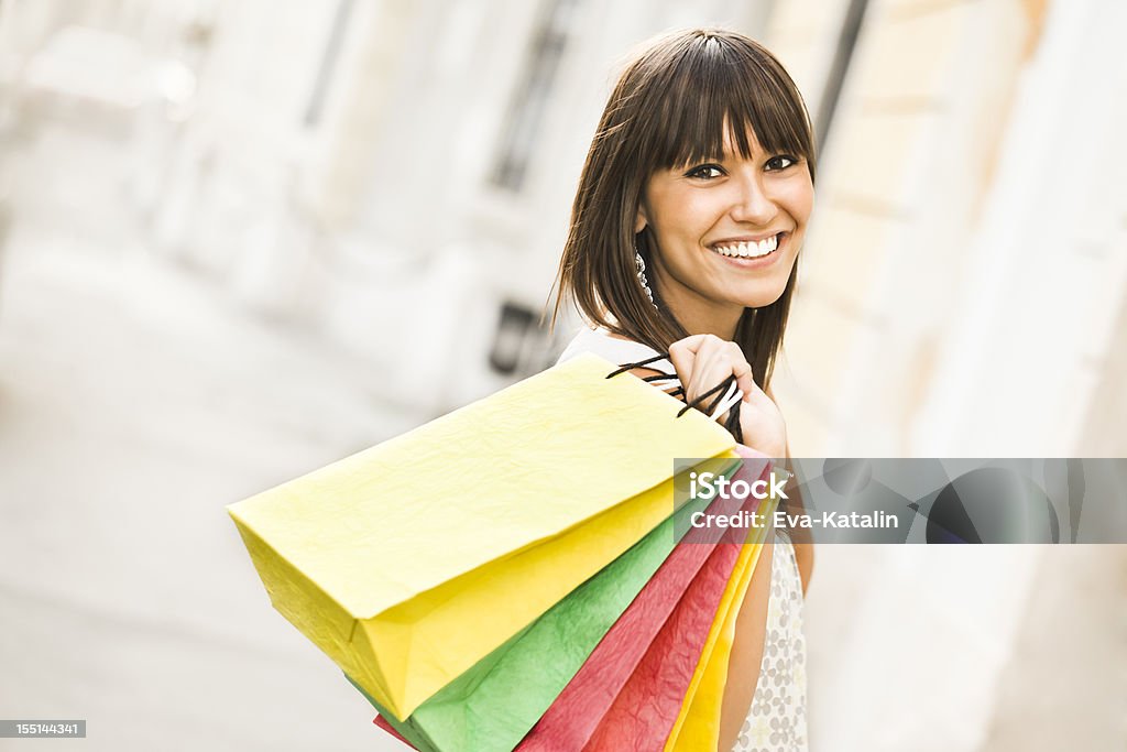 Miejskie życie serii: Szczęśliwa kobieta gospodarstwa torby na zakupy - Zbiór zdjęć royalty-free (20-29 lat)