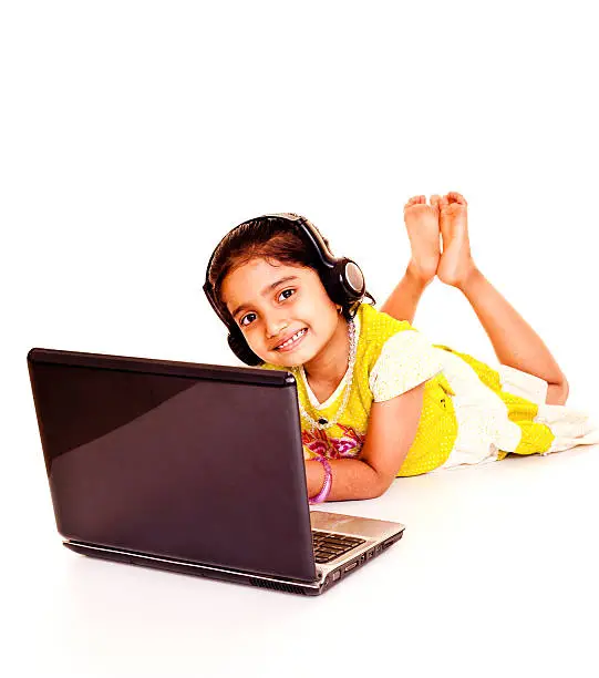 Photo of Cheerful Little Indian Girl Using Laptop Isolated on White Background