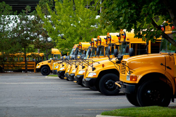 Classic yellow school bus is parked on a street in new york city, with pedestrians walking by