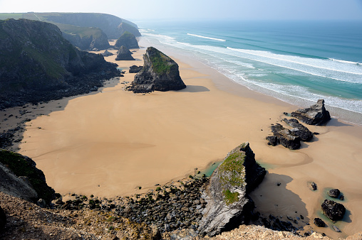 Man on a flysch looking at the Cantabrian Sea on Itzurun beach in Zumaia, Spain. Wanderlust.