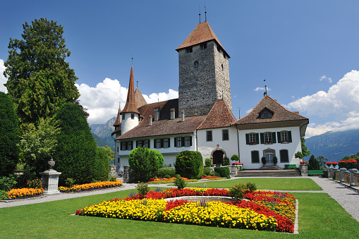The Château de Spiez (Schloss Spiez) with garden view. This medieval fortress is situated by the picturesque Lake thurn in the small town of Spiez in the Canton of Bern, Switzerland. It is a national heritage site in Switzerland.