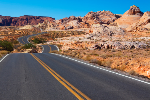 Winding road in desert landscape of Valley of Fire State Park, Nevada.