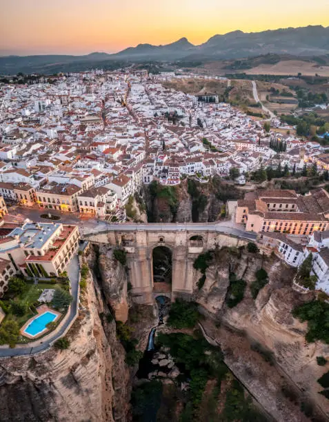 Aerial view of Ronda early in the morning. Puente nuevo bridge in the front. Ronda is a town in the Spanish province of Málaga. Ronda is known for its cliff-side location. Vertical panorama photo