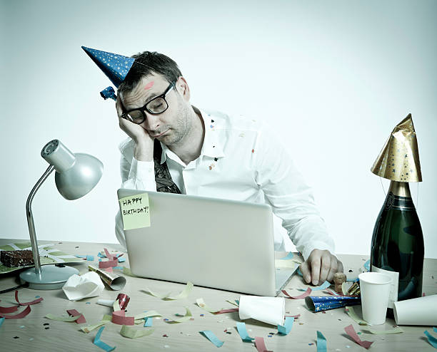 istock Happy Birthday, hungover man behind laptop, office interior, retro look 155144845