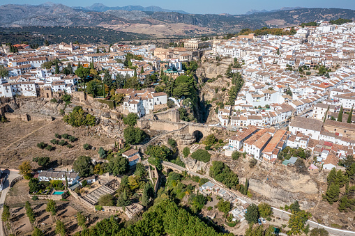 Ronda and Puente Viejo (Old Bridge) . Aerial view of houses, Arab Baths Archaeological Site and cathedral in Ronda, Andalusia, Spain