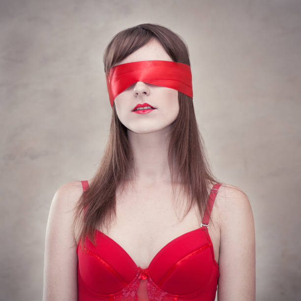 Sensual woman blindfolded Portrait of a young blindfolded woman wearing red lingerie red blindfold stock pictures, royalty-free photos & images
