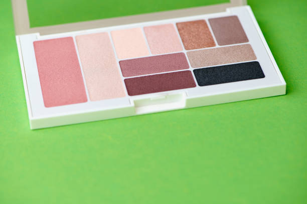 istock new palette with eye shadow and blush in different colors against green background 1551449298