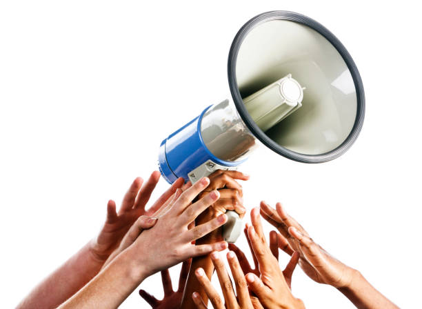istock My turn to talk! Many hands grabbing loud hailer 155144982