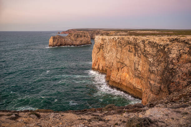 istock Cliffs and Pedra das Gaivotas rock island in Cabo Sao Vicente at sunset 1551450441