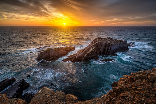 dark sunset over atlantic sea at Ponta da Atalaia, Vicentine Coast, Aljezur, Algarve, Portugal