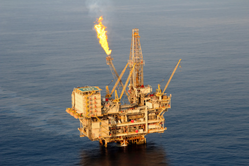 Close up aerial photograph of a fixed drilling platform oil rig.