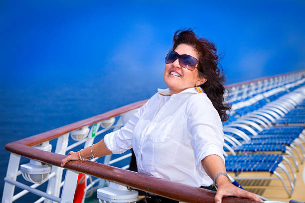 istock Happy relaxed woman enjoying on a cruise ship main deck 155145703