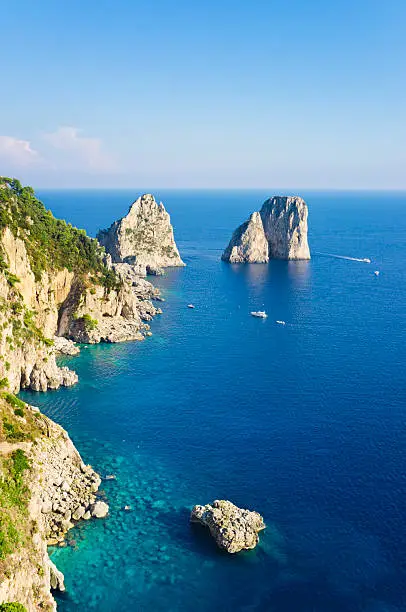 Faraglioni rocks, near coast of Capri Island (Italy, Bay of Naples)