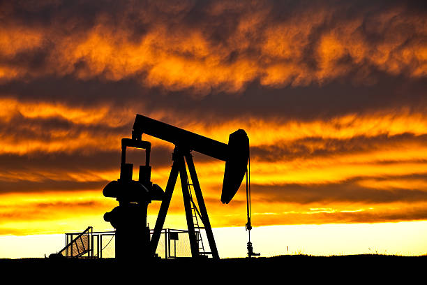 Oil Industry Silhouette  oil pump oil industry alberta equipment stock pictures, royalty-free photos & images