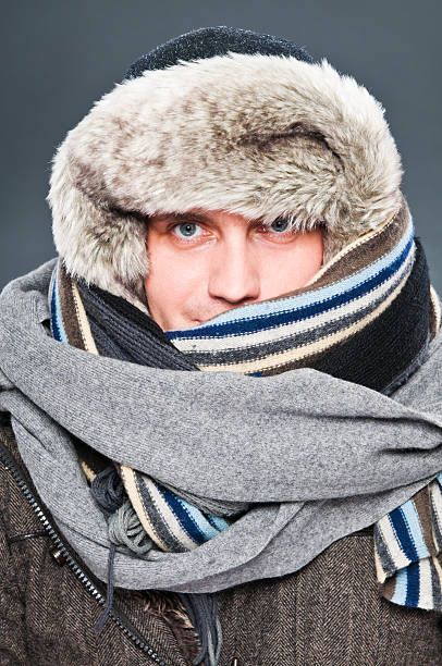 istock Man in winter clothes is tightly wrapped with cap, scarves 155145853