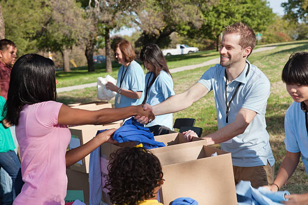 istock Donation center volunteer thanking donator 155145900