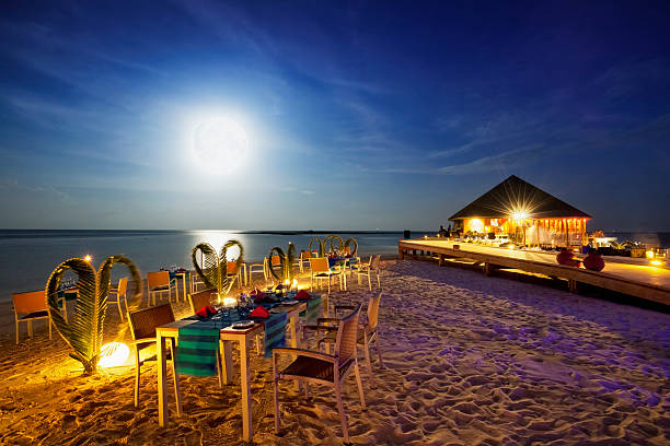 Full Moon Dinner - Vilamendhoo Island Resort Maldives Dinner on a beach on the Maldives (Vilamendhoo Island Resort) at Full Moon. restaurant place setting dinner dinner party stock pictures, royalty-free photos & images