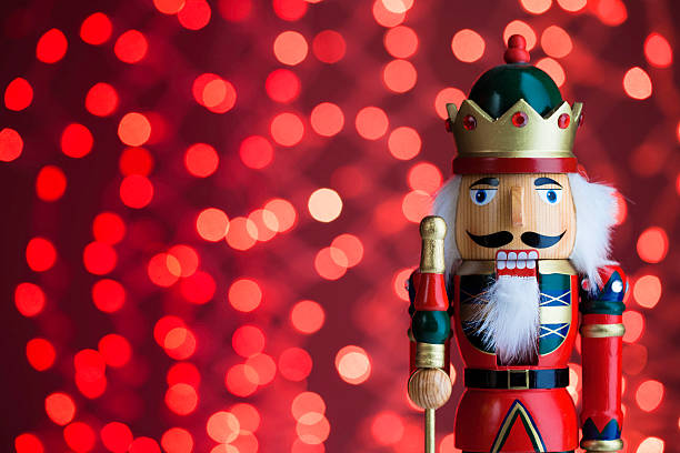Nutcracker Red Traditional nut cracker with defocused Christmas lights background nutcracker photos stock pictures, royalty-free photos & images