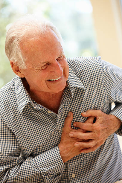 istock Senior man grasps chest due to pain 155146361