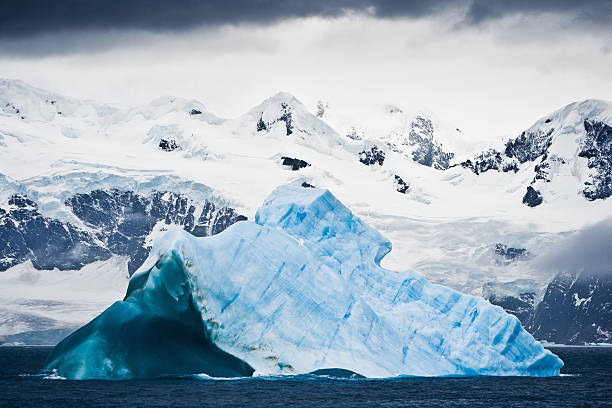 Antarctica Untouched Nature Iceberg and Snowy Mountains South Pole  iceberg dramatic sky wintry landscape mountain stock pictures, royalty-free photos & images