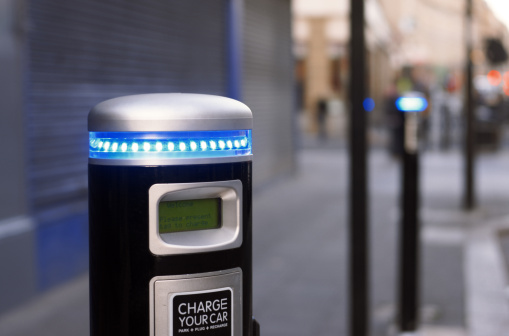 Brightly lit electric car charging point, photographed in a street in Newcastle-upon-Tyne, England, Autumn 2011